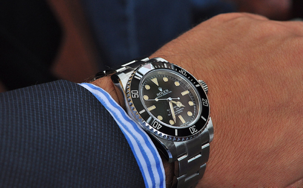 rolex-submariner-114060-dive-watch-on-hand-with-sleeve